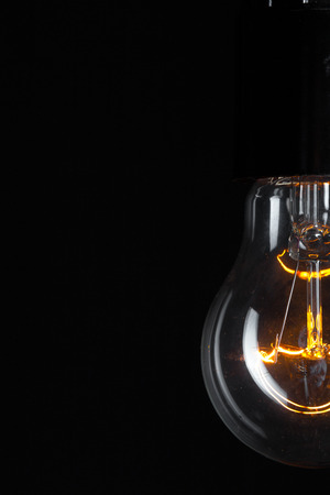A classic Edison light bulb on dark background with space for textの写真素材