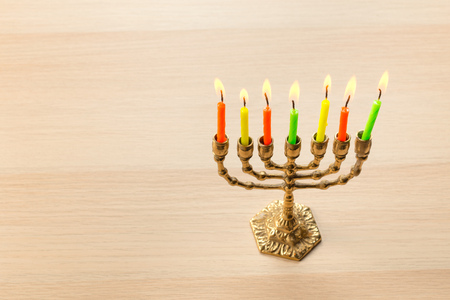 Bronze Hanukkah menorah with burning candles
