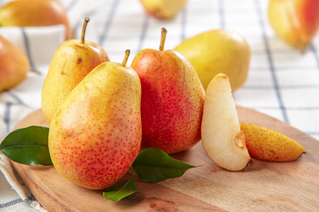 organic pears laying down on a lightly dotted kitchen cloth