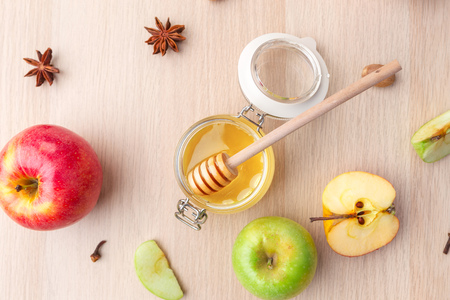 Jewish holiday Rosh Hashanah background with honey and apples on wooden table.の写真素材