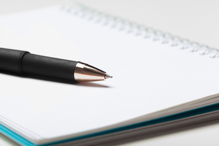 notepad notebook and ball pont pen isolated on white backgroundの写真素材