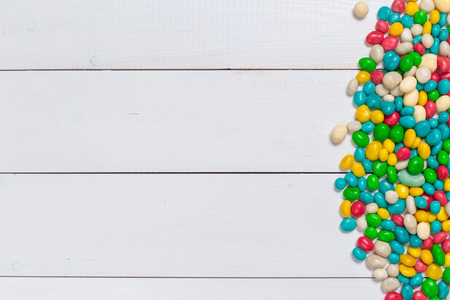 Colorful candies on wooden background