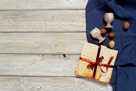 Jewish holiday Passover banner design with wine, matzo on wooden background.