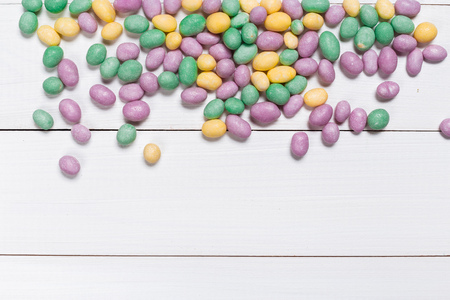Colorful candies on wooden background