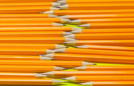 Colorful pencils on a bright green paper backgroundの写真素材
