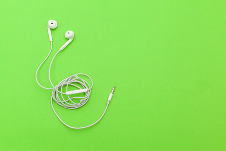 Earphons on color background.