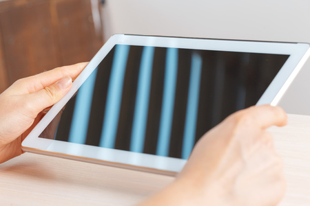 woman holding digital tablet, closeup