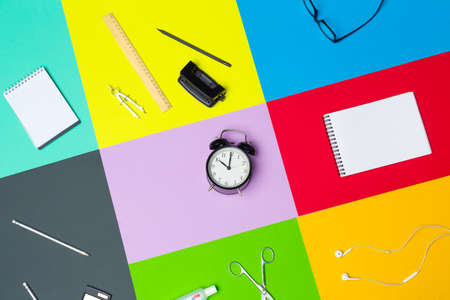 school supplies at colorful paper backgroundの写真素材