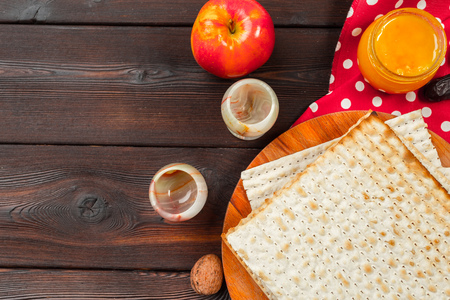 Jewish holiday Passover banner design with wine, matzo on wooden background.の写真素材