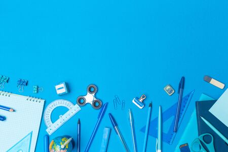 school supplies at colorful paper backgroundの写真素材