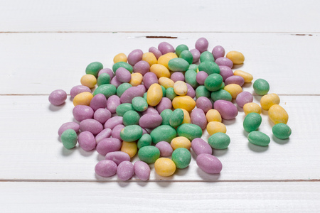 Colorful candies on wooden background