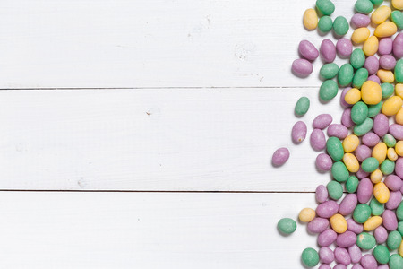 Colorful candies on wooden background