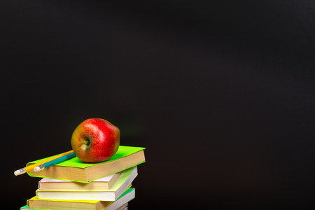 red apple and old books on wooden tabletopの写真素材