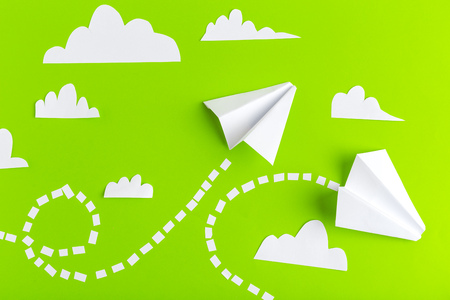 Paper airplanes  connected with dotted lines on green background. Business conceptの写真素材