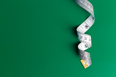 Measure tape on a green