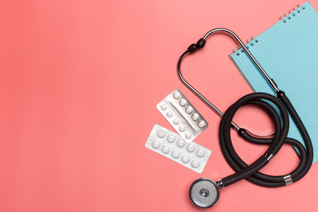 Medical equipment on a pink pastelの写真素材