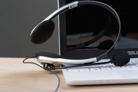 Headset on keyboard computer laptopの写真素材