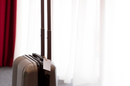 Suitcase or luggage bag in a modern hotel roomの写真素材