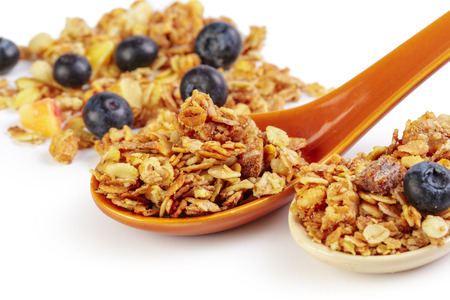 Granola spoon with billberry isolated on white background