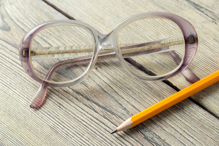 eyeglasses on wooden tableの写真素材