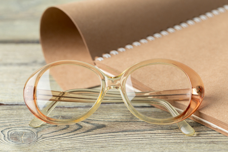 notepad and eyeglasses on the tableの写真素材