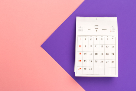Calendar page on bright bicolor background, top viewの写真素材