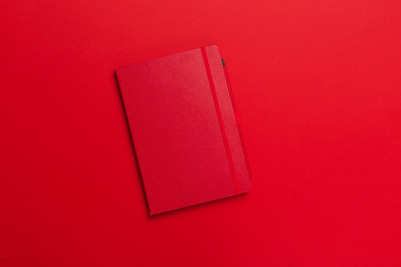 Notepad on a bright colored background, top viewの写真素材