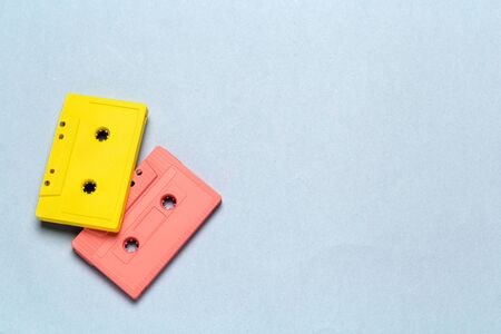 Bright retro cassette tapes on a light grey background