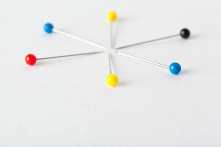 Colorful pushpins on a white board. School or business concept