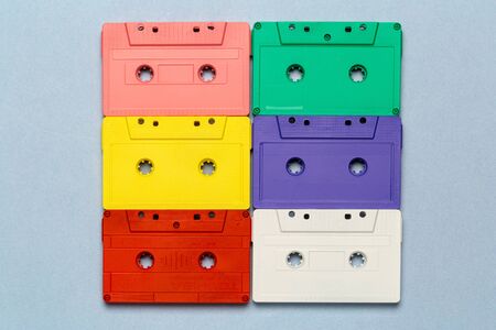 Bright retro cassette tapes on a light grey background. creative photoの写真素材