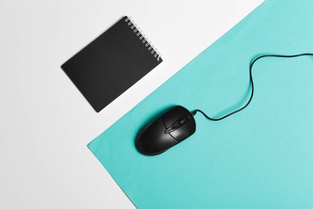 Computer mouse on a turquoise paper background. creative photo.