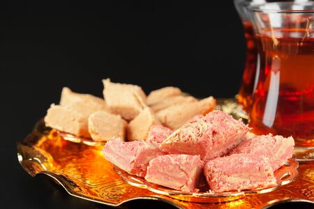 Bowl with pieces of turkish delight lokum and black tea
