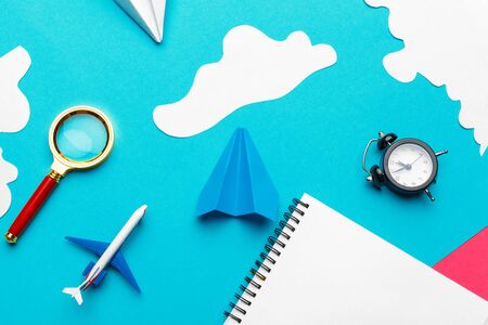 Paper plane on a blue background with clouds. creative photo.の写真素材