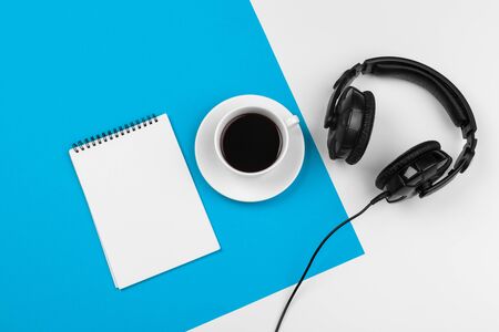 Stylish headphones on blue and white color background, top view.の写真素材