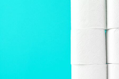 Toilet paper rolls on turquoise bright backgroundの写真素材