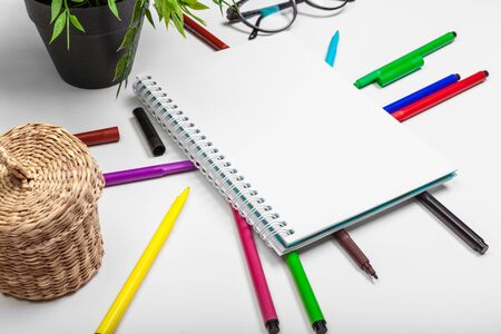 Set of felt tip markers in different colors and a blank sketchbook with a space for textの写真素材