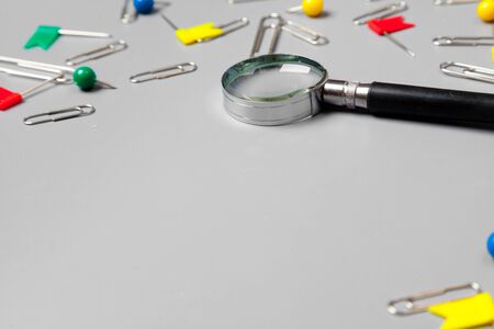 magnifying glass with paper clips on grey background.minimalism conceptの写真素材