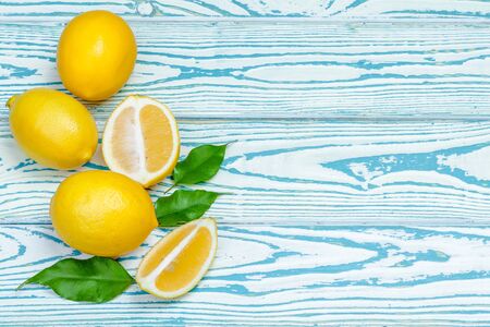 fresh lemons on wooden table.の写真素材
