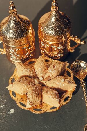 Turkish sweets with coffee on a wooden table. Creative photo.の写真素材