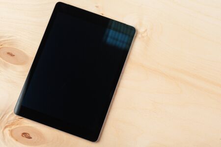 digital tablet on wooden table. Creative photo.の写真素材