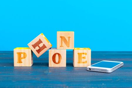 cube wooden block with alphabet building the word phone. creative photo.の写真素材