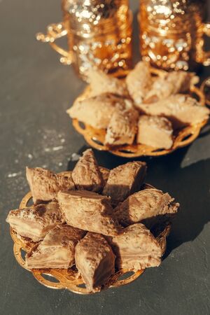 Turkish sweets with coffee on a wooden table. creative photo.の写真素材
