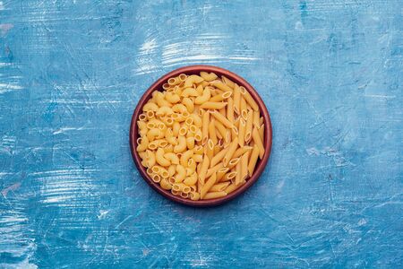 Italian pasta in plate on a blue wooden table