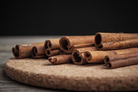 Cinnamon sticks on wooden background.の写真素材