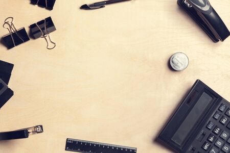 Overhead shot of a desk with various office tools, and calculator. creative photo.の写真素材