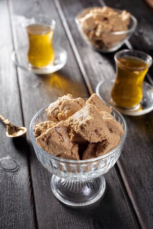Tasty halva with tea on the table. creative photo.