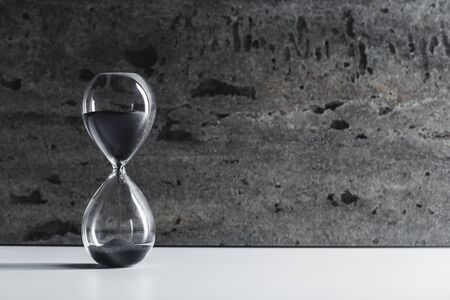 Hourglass on dark background. creative photo.の写真素材