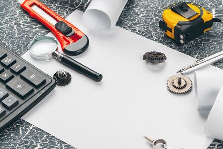 safety helmet and Scrolls of engineering drawings and supplies. creative photo.