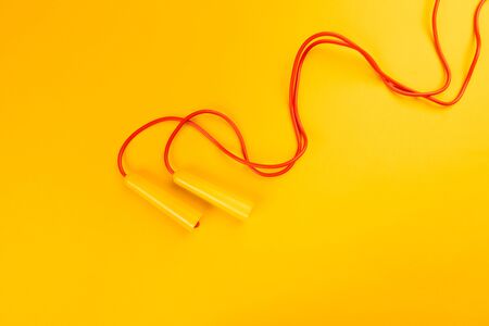 Jumping rope on yellow backgroundの写真素材