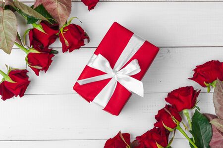 St. Valentines Day. Red roses and gift box on wooden table. creative photo.の写真素材